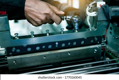 Mechanic Technician Hand Fixing Industrial Machinery In Factory. Technician Service And Maintenance Packing Machine Equipment. Worker Use Wrench Maintenance Industrial Machinery In Plant.