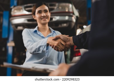 Mechanic Technician Man Shaking Hands With Customer After Finish Checking The Car At The Garage, Two People Handshake For A Working Job At Professional Auto Car Repair Service Center