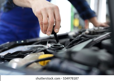 Mechanic Tightened The Valve Steering Fluid Reservoir. Car Mechanic Exchanges Steering System Fluid. 