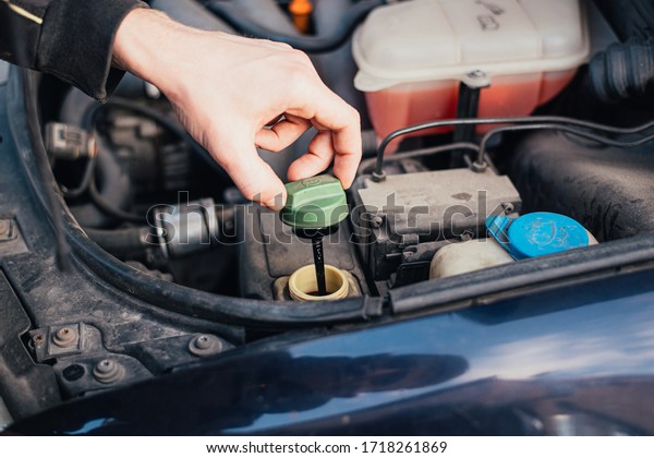 Mechanic tightened the\
valve steering fluid reservoir. Car mechanic exchanges steering\
system fluid.