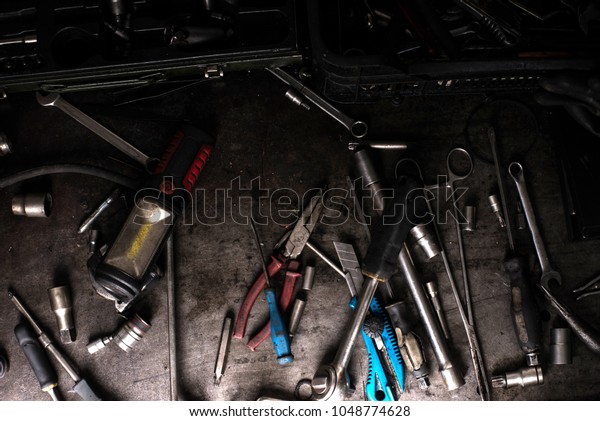 Mechanic tools on dirty metal desk. Car wrenches,\
screwdrivers. Garage tools.\
