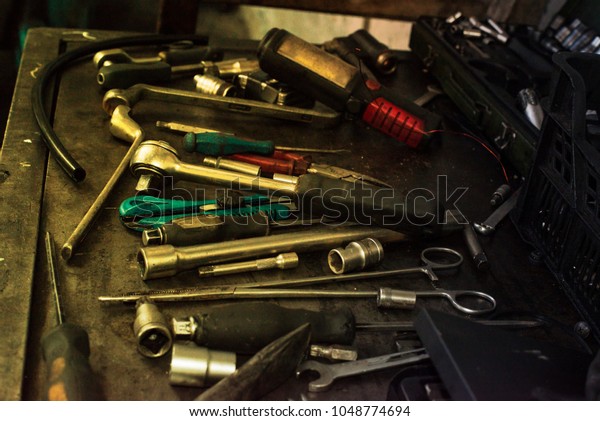 Mechanic tools on dirty metal desk. Car wrenches,
screwdrivers. Garage tools.
