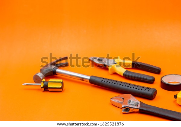 Mechanic tools are on\
orange background
