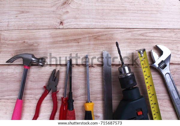 Mechanic tools set or Assorted work tools on\
wooden background