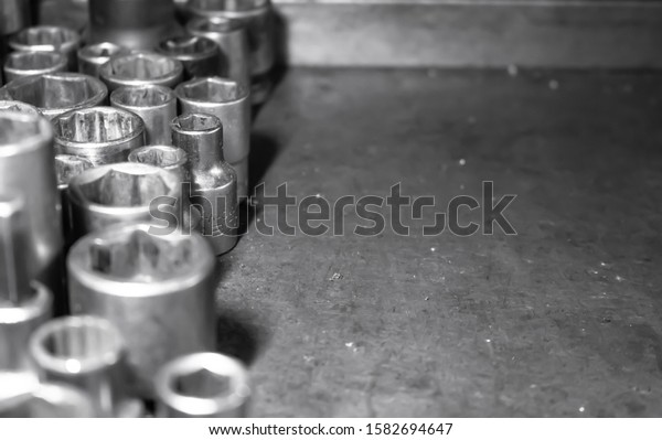 Mechanic tools set on\
metal background. Vintage style image of blank space on metal, lot\
of old tools. Copy space. Car service and repair concept. Tools on\
working table.