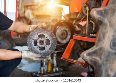 Mechanic Tractor Working Under The Car And Clutch At Car Repair Shop Tractor