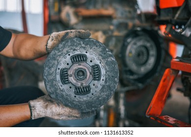 Mechanic Tractor Working Under The Car And Clutch At Car Repair Shop Tractor