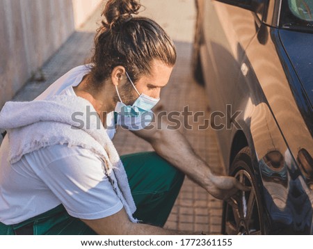 a mechanic trying to fix a car wheel
