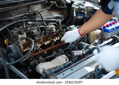 The Mechanic Is Tuning The Car's Engine.