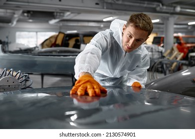 Mechanic in uniform sanding painted car body - Powered by Shutterstock