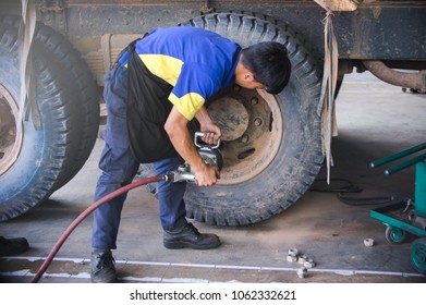 Mechanic Unscrews Wheel Truck Pneumatic Wrench