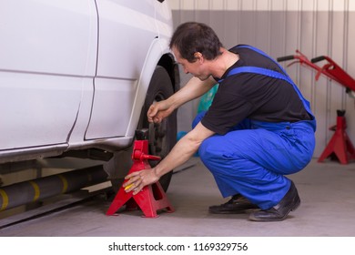 Mechanic Uses Jackscrew In The Auto Service