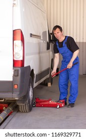 Mechanic Uses Jackscrew In The Auto Service