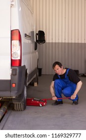 Mechanic Uses Jackscrew In The Auto Service