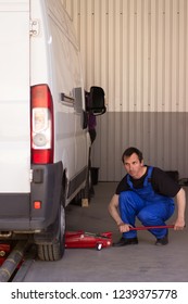 Mechanic Uses Jackscrew In The Auto Service