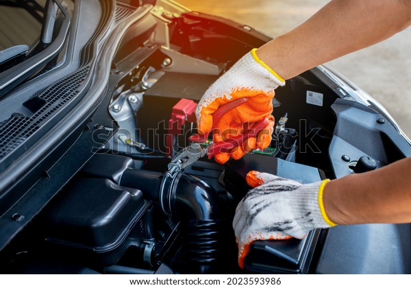 The mechanic uses pliers to check the condition of\
the car and fix the car.