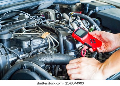 Mechanic is using a diagnostic car code reader.Car Computer Error Reading Using Mobile Device.