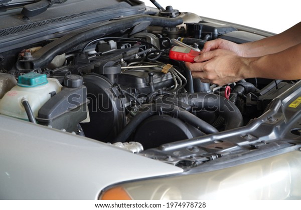 Mechanic is using a diagnostic car\
code reader.Car Computer Error Reading Using Mobile\
Device.