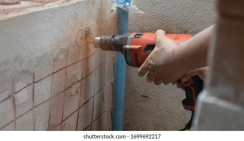 Mechanic Using Drill For Installation