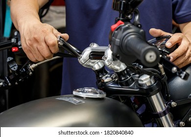 mechanic using Hex Key Wrench working on motorcycle at motorbike garage , concept of motorcycle maintenance and repair . selective focus - Powered by Shutterstock