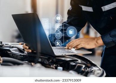 Mechanic using laptop checking up on car engines parts for fixing and repair, Smart service diagnostics software concept. - Powered by Shutterstock