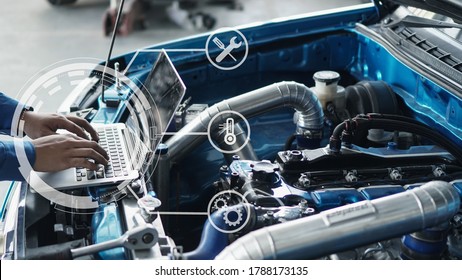 Mechanic Using Laptop Computer Working Tuning On Car For The Efficiency Of The Race Car In Garage.maintenance Concept