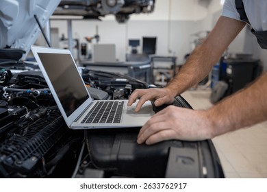 Mechanic using laptop for diagnostics