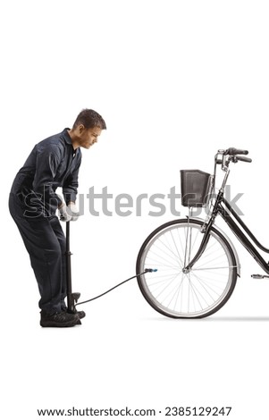 Mechanic using a manual pump for a flat front tire of a bicycle isolated on white background