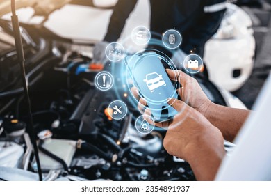 Mechanic using smart phone checking up on car engines parts for fixing and repair, Smart service diagnostics software concept. - Powered by Shutterstock