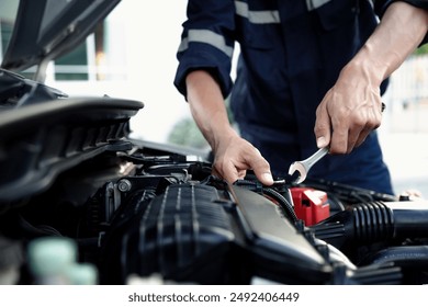 Mechanic are using the wrench to repair and maintenance auto engine at car repair shop,Car auto services and maintenance check concept. - Powered by Shutterstock