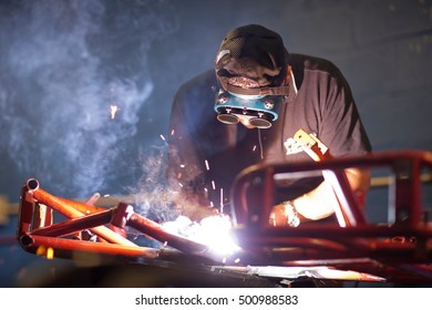 Mechanic Welding Go Cart In Workshop