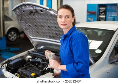 Mechanic wiping hands with rag at the repair garage - Shutterstock ID 252012484