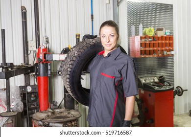 A Mechanic Woman Working On Car In His Shop