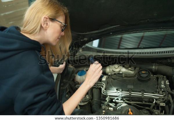 Mechanic woman working on\
car