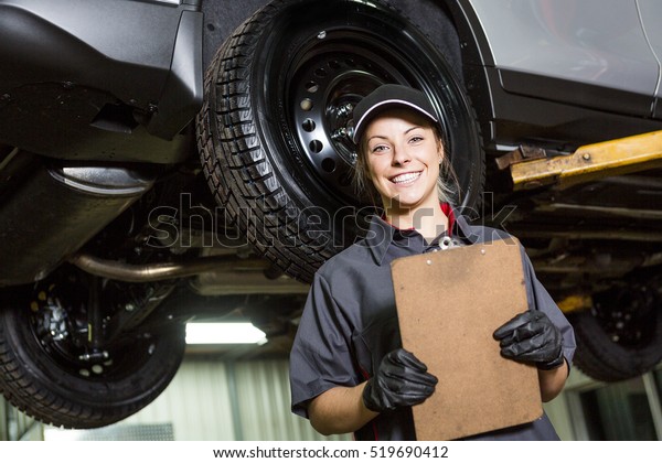 A Mechanic\
woman working on car in his\
shop