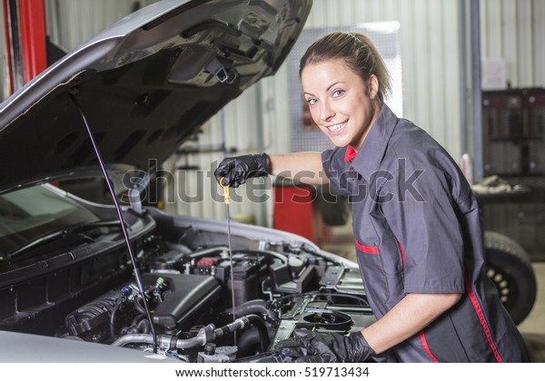 A Mechanic\
woman working on car in his\
shop