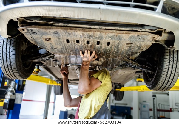 mechanic at\
work in car in repair station of\
vehicles