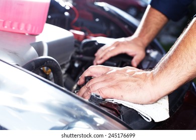 Mechanic working in auto repair garage. Car maintenance - Shutterstock ID 245176699