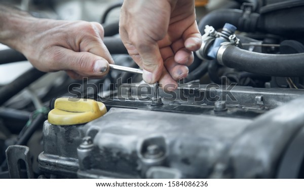 Mechanic working in car motor. Auto repair,\
Service center