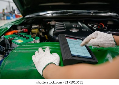 Mechanic working at car service center Perform car and engine diagnostic scans using OBD and OBD2 devices on your tablet to fix problems in your garage or repair shop. which is an electronic system