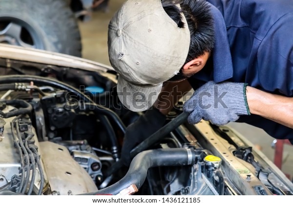 Mechanic working with car
spare parts.