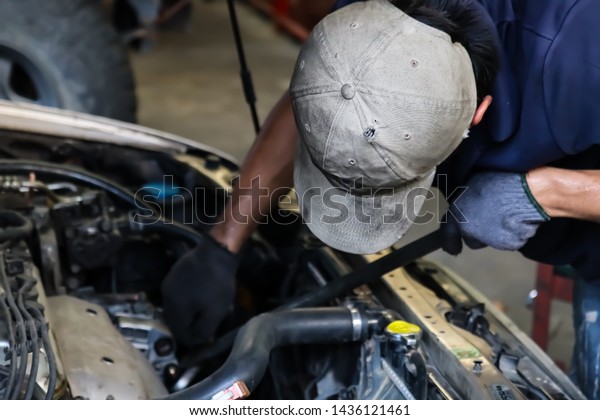 Mechanic working with car\
spare parts.