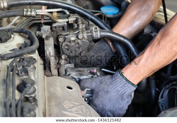 Mechanic working with car\
spare parts.