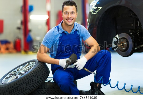 Mechanic working on\
car in auto repair\
shop\
