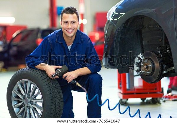 Mechanic working on\
car in auto repair\
shop\

