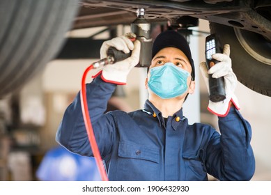 Mechanic Working On A Car, Covid Coronavirus Work Concept