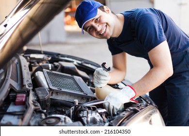 Mechanic Working On A Car Engine