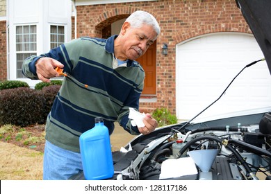 Mechanic Working On A Car In His Driveway