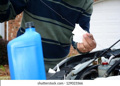 Mechanic Working On A Car In His Driveway