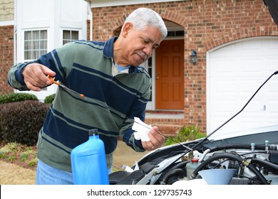 Mechanic Working On A Car In His Driveway